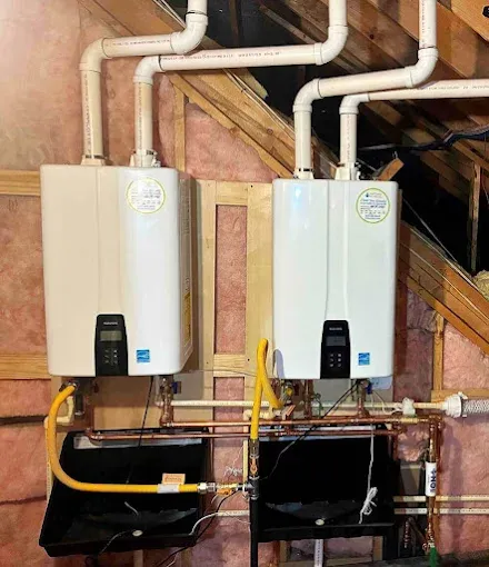 Two modern Navien units mounted side-by-side in a residential attic, showcasing a professional installation ready for routine tankless water heater maintenance.
