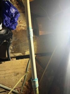 Repaired PVC condensate drain line with fresh cement joints in crawl space in Rowlett, TX