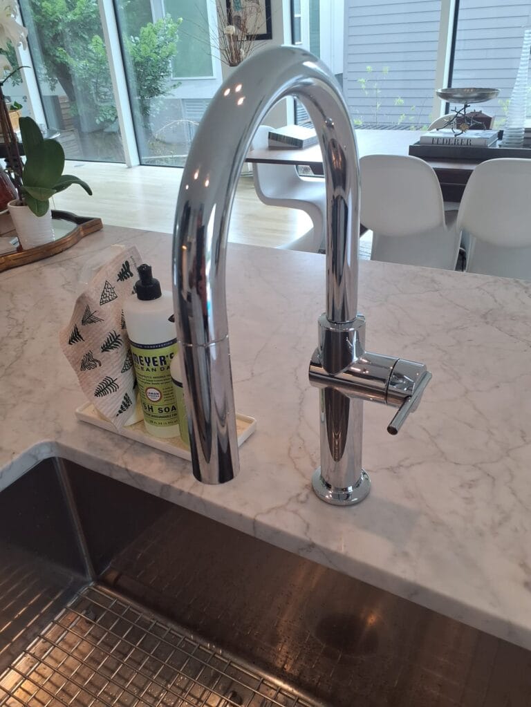 Newly installed chrome gooseneck kitchen faucet in a Royse City home after service by Intown Plumbing